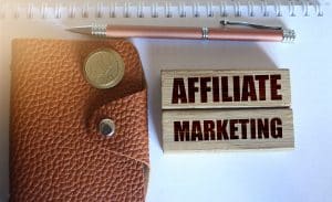 Affiliate Marketing Typed On Wooden Blocks, Wallet, Coins, Pen.