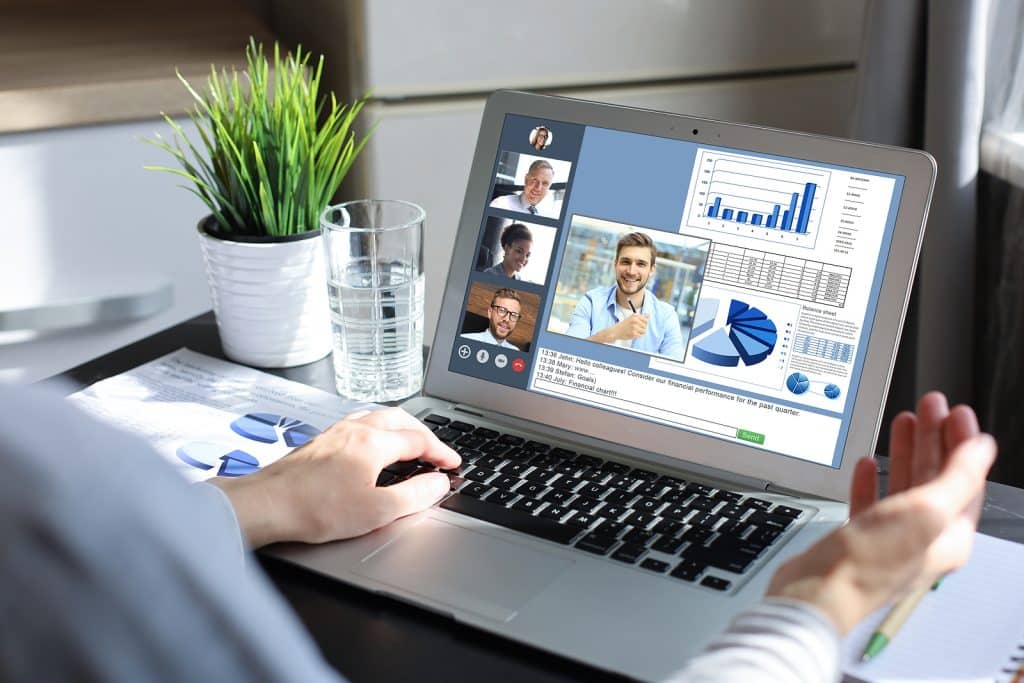 Business woman talking to her colleagues in video conference. 